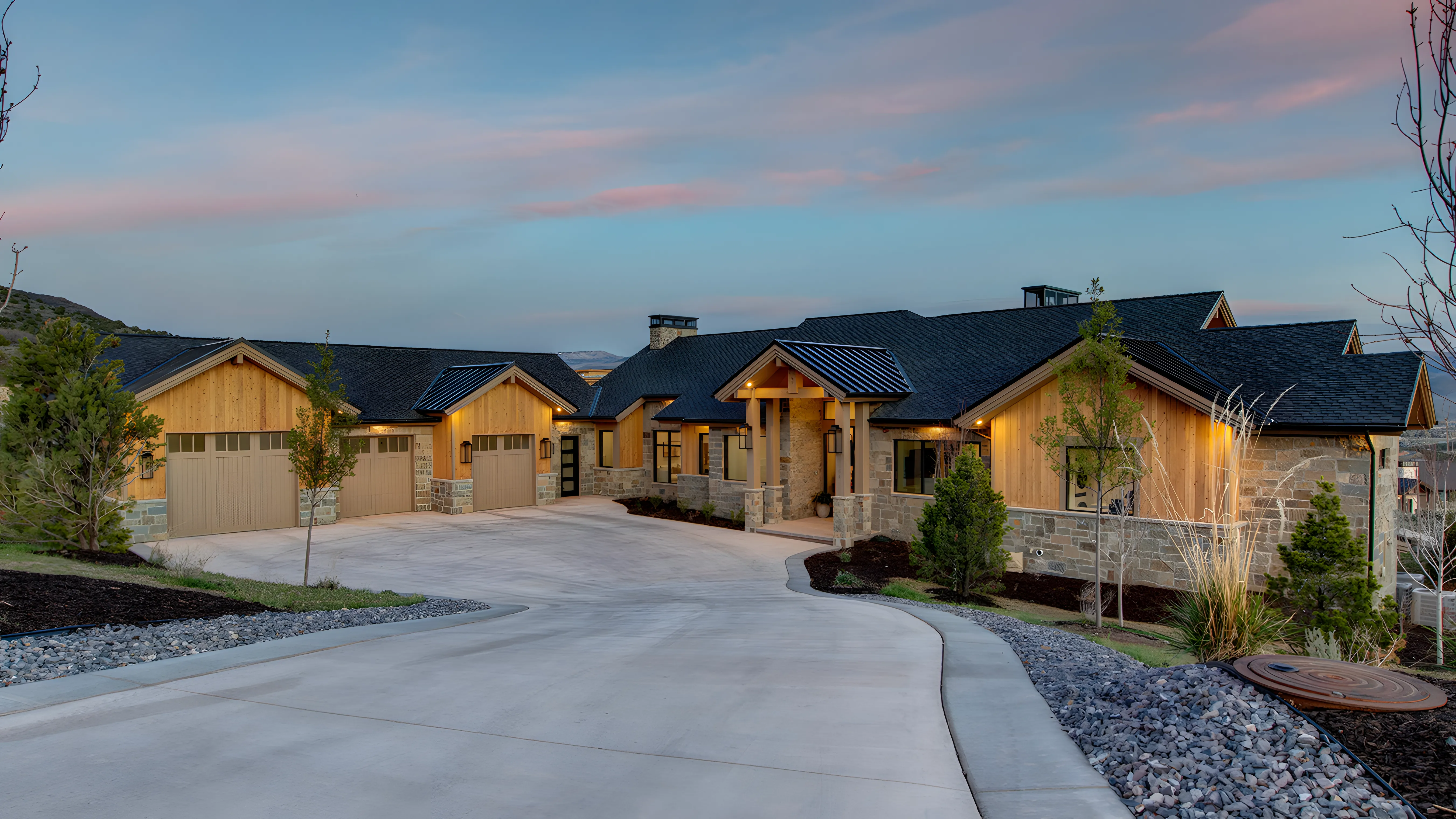 Mountain Modern Estate dusk exterior with stone and timber facade