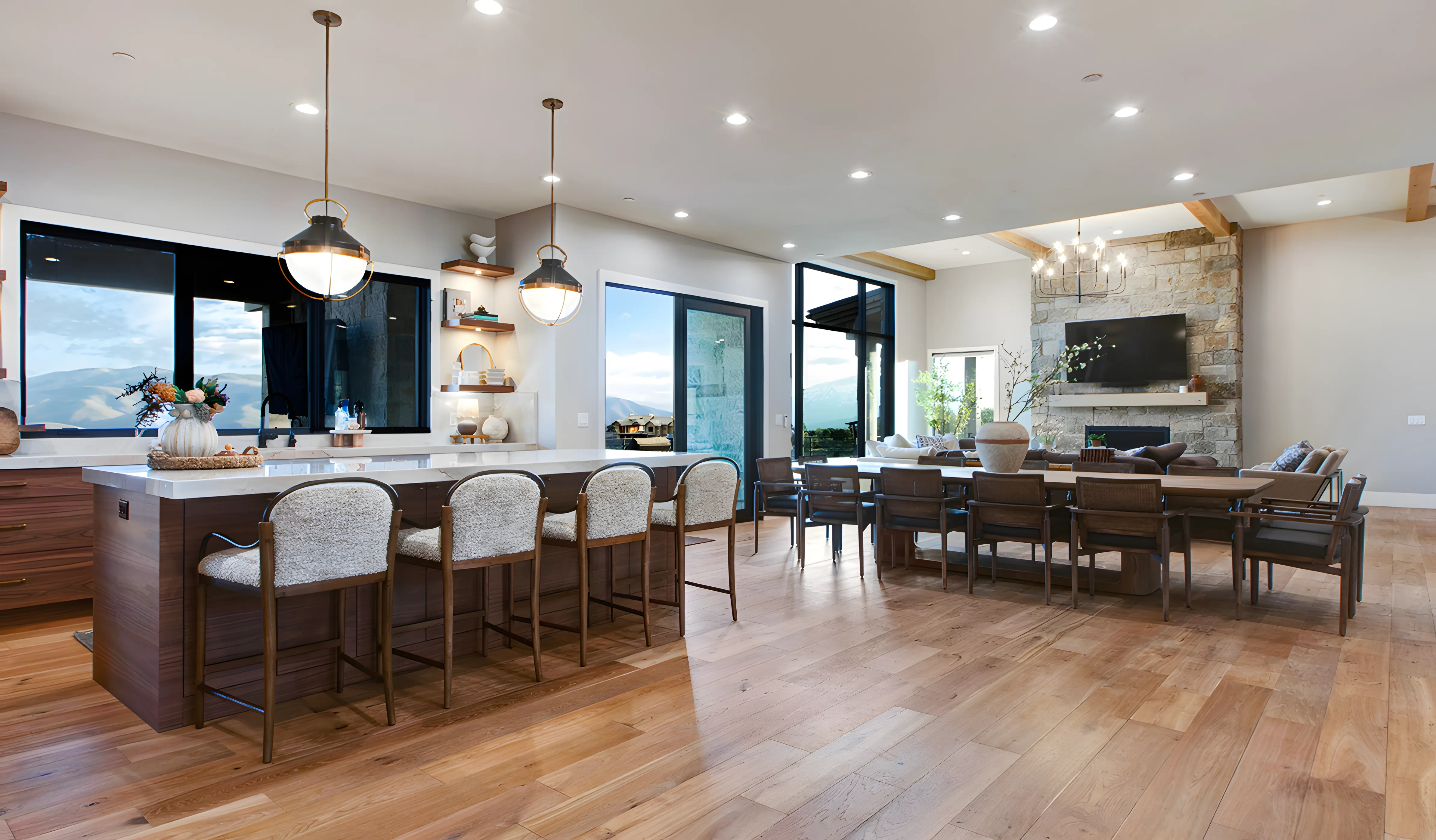 Mountain Modern Estate open kitchen and dining with stone fireplace