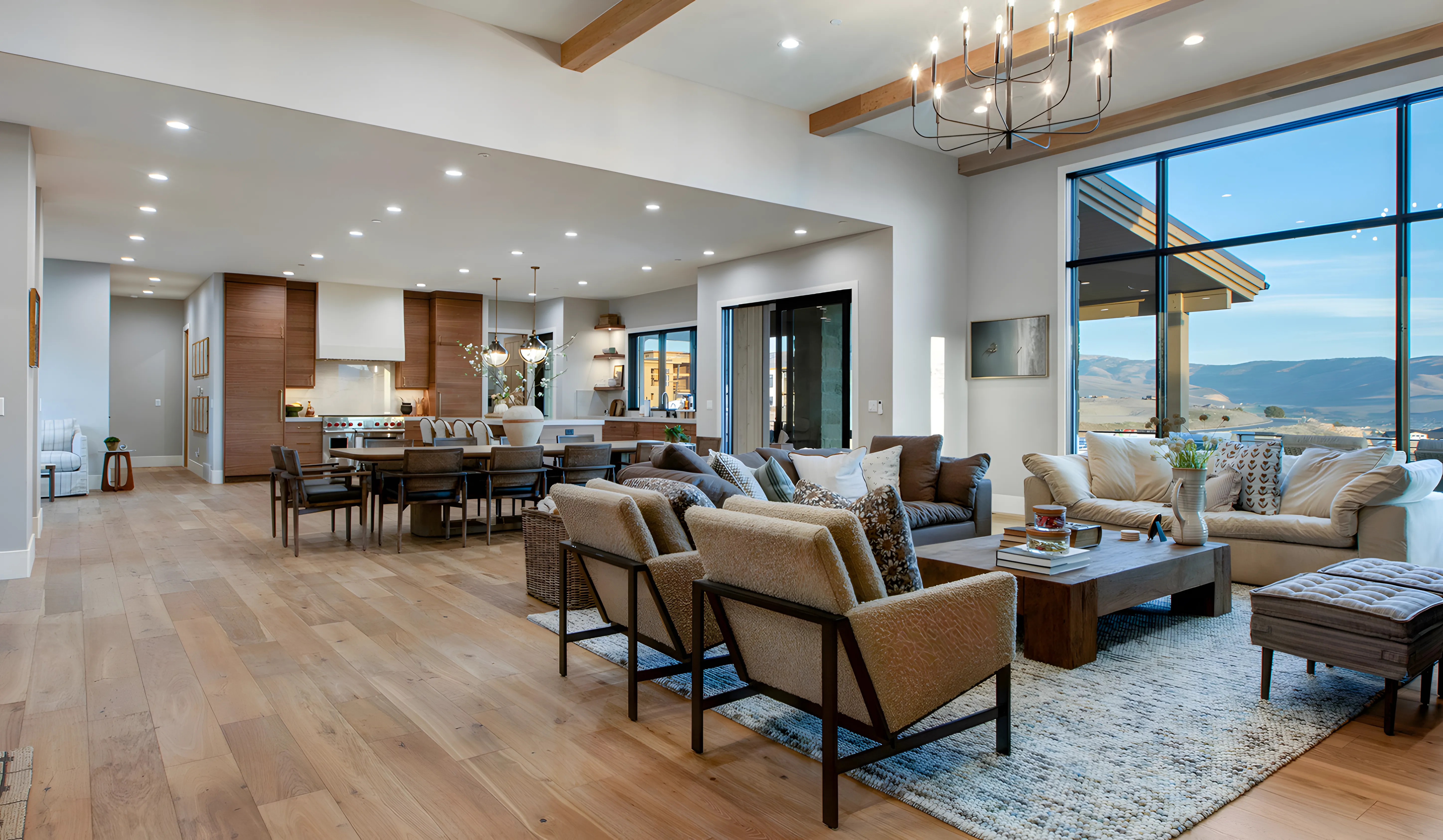 Mountain Modern Estate great room with exposed beams and panoramic mountain views